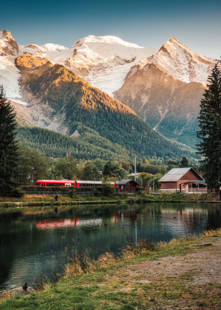 Beautiful view of Lac des Gaillands with Mont Blanc massif and train at station in the sunset at Chamonix, Savoie, France