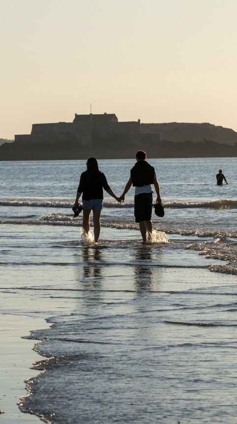 couple walking seaside saint malo brittany